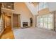 Bright living room features a stone fireplace, plush carpeting, and large windows for natural light at 203 Crescent Moon Way Way, Canton, GA 30114