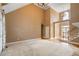 Spacious living room featuring vaulted ceiling, plush carpet and hardwood entryway at 203 Crescent Moon Way Way, Canton, GA 30114