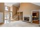Open-concept living space with a stone fireplace, hardwood floors, and adjacent kitchen at 203 Crescent Moon Way Way, Canton, GA 30114