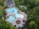 Aerial view of community pools with lush trees and lounge chairs at 203 Crescent Moon Way Way, Canton, GA 30114
