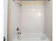 Close-up of the bathtub with white tiled walls and shower head at 203 Crescent Moon Way Way, Canton, GA 30114
