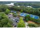 Aerial view of tennis courts, lake, parking lot, and lush trees at 203 Crescent Moon Way Way, Canton, GA 30114