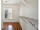 Walk-in closet with wooden floors and metal shelving with light entering from a window at 203 Crescent Moon Way Way, Canton, GA 30114
