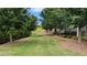 Expansive back yard with lush lawn, mature trees, and manicured landscaping at 301 Hayden Cir, Woodstock, GA 30189