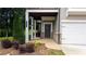 Inviting front entrance with covered porch and manicured landscaping at 301 Hayden Cir, Woodstock, GA 30189