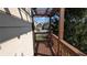 View from the home's wood-floored balcony of the community street, front yards, and beautiful blue sky above at 301 Hayden Cir, Woodstock, GA 30189