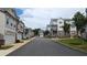 Exterior view of townhomes along a well-maintained street with sidewalks, landscaping, and attached garages at 301 Hayden Cir, Woodstock, GA 30189