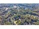 An aerial view of a charming home site with a lush surrounding of mature trees and other community residences at 3081 Frankie Ln, Duluth, GA 30096