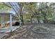 Spacious backyard with a covered patio, mature trees, and a storage shed at 3081 Frankie Ln, Duluth, GA 30096