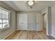 This bedroom features hardwood floors, a ceiling fan, and a double-door closet at 3081 Frankie Ln, Duluth, GA 30096