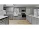Gray kitchen features a farmhouse sink, stainless appliances, and ample countertop space at 3081 Frankie Ln, Duluth, GA 30096