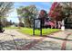 Peaceful park view features greenery, American flags, and a community message board at 3081 Frankie Ln, Duluth, GA 30096