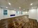 Finished basement with recessed lighting, wood flooring, windows, and a modern fireplace at 365 Morning Dew Cir, Roswell, GA 30075