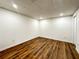 Finished basement room with wood flooring, white walls, and recessed lighting at 365 Morning Dew Cir, Roswell, GA 30075
