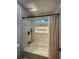 Bathtub and shower combo with white tile surround and a built-in shelf at 365 Morning Dew Cir, Roswell, GA 30075