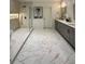 Modern bathroom with marble flooring, dual sinks, and a glass-enclosed shower at 365 Morning Dew Cir, Roswell, GA 30075