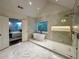 Luxurious primary bathroom featuring a soaking tub, glass shower, and marble tile at 365 Morning Dew Cir, Roswell, GA 30075