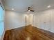 A bright bedroom featuring hardwood floors, a ceiling fan, and ample closet space at 365 Morning Dew Cir, Roswell, GA 30075