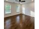 Bedroom with hardwood floors, a ceiling fan, and natural light from two windows at 365 Morning Dew Cir, Roswell, GA 30075