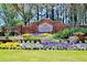 A brick community welcome sign surrounded by colorful flowers at 365 Morning Dew Cir, Roswell, GA 30075