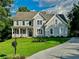 Charming home featuring well-manicured lawn, gray siding, and manicured garden at 365 Morning Dew Cir, Roswell, GA 30075