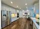 Modern kitchen featuring stainless steel appliances, marble countertops, and dark wood flooring at 365 Morning Dew Cir, Roswell, GA 30075