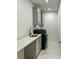 Modern laundry room with marble floors, gray cabinets, and a new washing machine at 365 Morning Dew Cir, Roswell, GA 30075