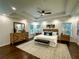 Spacious main bedroom with a tray ceiling, hardwood floors, and lots of natural light at 365 Morning Dew Cir, Roswell, GA 30075