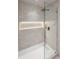 Modern walk-in shower featuring sleek fixtures and a built-in illuminated niche at 365 Morning Dew Cir, Roswell, GA 30075