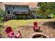 Expansive backyard with a multi-tiered deck, outdoor seating, fire pit, and lush green landscaping at 3990 Wesley Chapel Rd, Marietta, GA 30062