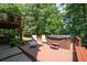 Backyard deck featuring a hot tub, lounge chairs, and stairs to a second level deck at 3990 Wesley Chapel Rd, Marietta, GA 30062