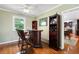 Hardwood bar with barstools and custom bar, conveniently attached to the kitchen at 3990 Wesley Chapel Rd, Marietta, GA 30062