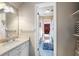 Bathroom with blue tile floors, vanity sink, and a view into an adjacent bedroom creating an open feel at 3990 Wesley Chapel Rd, Marietta, GA 30062