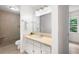 Bathroom featuring a tile shower, vanity with sink, and natural light, offering a clean and modern space at 3990 Wesley Chapel Rd, Marietta, GA 30062