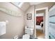 Bathroom with surfboard decor and a view into an adjacent bedroom, offering a beachy, relaxed atmosphere at 3990 Wesley Chapel Rd, Marietta, GA 30062
