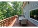 Spacious outdoor deck with dining set, ideal for enjoying the surrounding wooded views and outdoor dining at 3990 Wesley Chapel Rd, Marietta, GA 30062