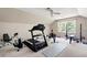 Home gym featuring a treadmill, rowing machine, and weightlifting equipment, all in a spacious room at 3990 Wesley Chapel Rd, Marietta, GA 30062