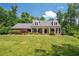Inviting single Gathering home with a covered front porch, dormer windows, and lush landscaping at 3990 Wesley Chapel Rd, Marietta, GA 30062