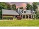 Charming single-Gathering home featuring a brick facade, front porch, manicured lawn, and mature landscaping at 3990 Wesley Chapel Rd, Marietta, GA 30062