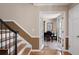 Entryway with hardwood floors, staircase, and double doors leading to another room with a piano at 3990 Wesley Chapel Rd, Marietta, GA 30062