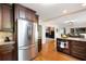 Open concept kitchen with stainless steel refrigerator and custom wood cabinets at 3990 Wesley Chapel Rd, Marietta, GA 30062