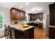 Eat-in kitchen with wooden bar stools, granite countertops, and modern appliances at 3990 Wesley Chapel Rd, Marietta, GA 30062