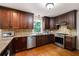 Gourmet kitchen features stainless steel appliances, wood cabinets, and granite countertops at 3990 Wesley Chapel Rd, Marietta, GA 30062