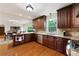 Gourmet kitchen with granite countertops, dark wood cabinetry, and stainless steel appliances at 3990 Wesley Chapel Rd, Marietta, GA 30062