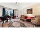 Cozy living room featuring a grand piano, decorative rug, and comfortable seating at 3990 Wesley Chapel Rd, Marietta, GA 30062