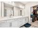 Bright bathroom featuring double sinks, white cabinets, and a walk-in closet at 4776 Highside Way, Smyrna, GA 30082