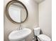 Elegant powder room with pedestal sink, decorative mirror, and toilet at 4776 Highside Way, Smyrna, GA 30082
