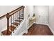 Welcoming entryway boasts hardwood floors, elegant staircase, and stylish console table at 4776 Highside Way, Smyrna, GA 30082