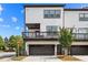 Stylish townhome exterior with modern design, a two-car garage, and private balcony at 4776 Highside Way, Smyrna, GA 30082