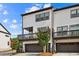 Charming townhome exterior with a modern facade, showcasing the garage and upper balcony at 4776 Highside Way, Smyrna, GA 30082